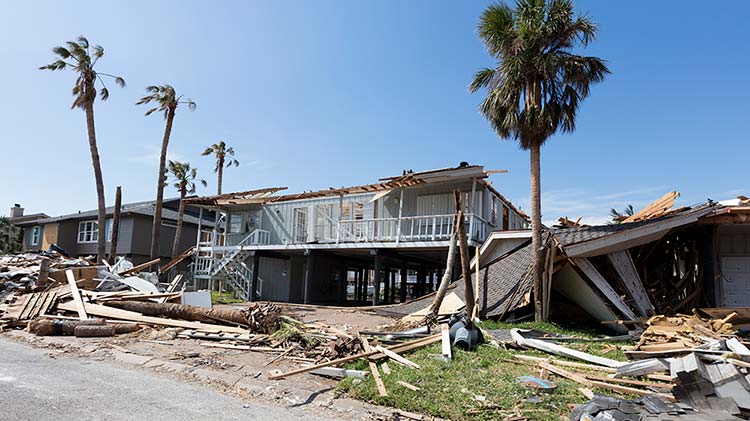 Storm damage to a house and surrounding buildings.