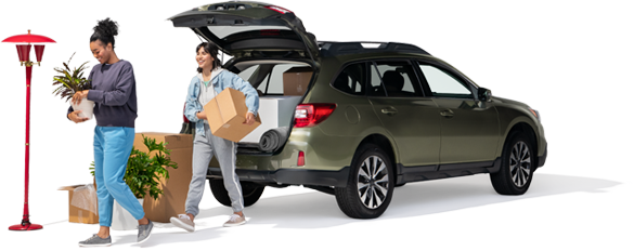 A mom and daughter unpack their SUV with home furnishings.