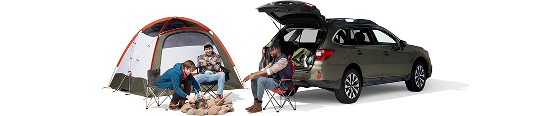 Three male friends gather around a fire pit with their tent and SUV hatchback opened.