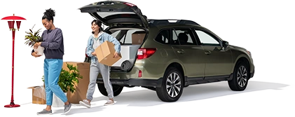 A mother and daughter remove household items from their SUV.