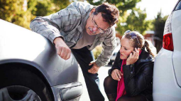 A couple check the damage to their car.