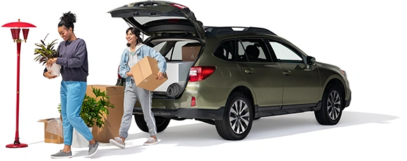 A mother and daughter unload home furnishings from their SUV.