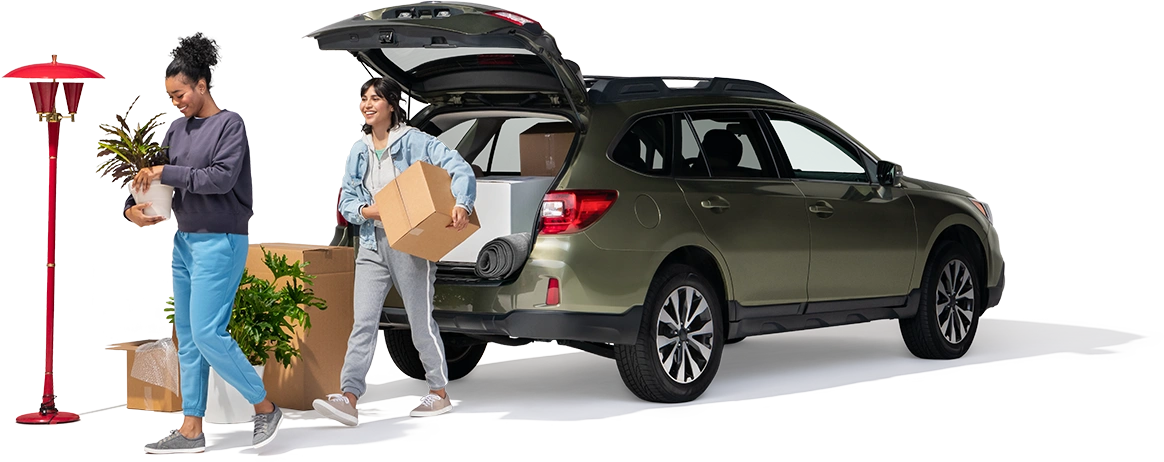 A mother and daughter remove household items from their SUV.