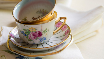 A couple of fine china cups sit nestled atop a couple of saucers